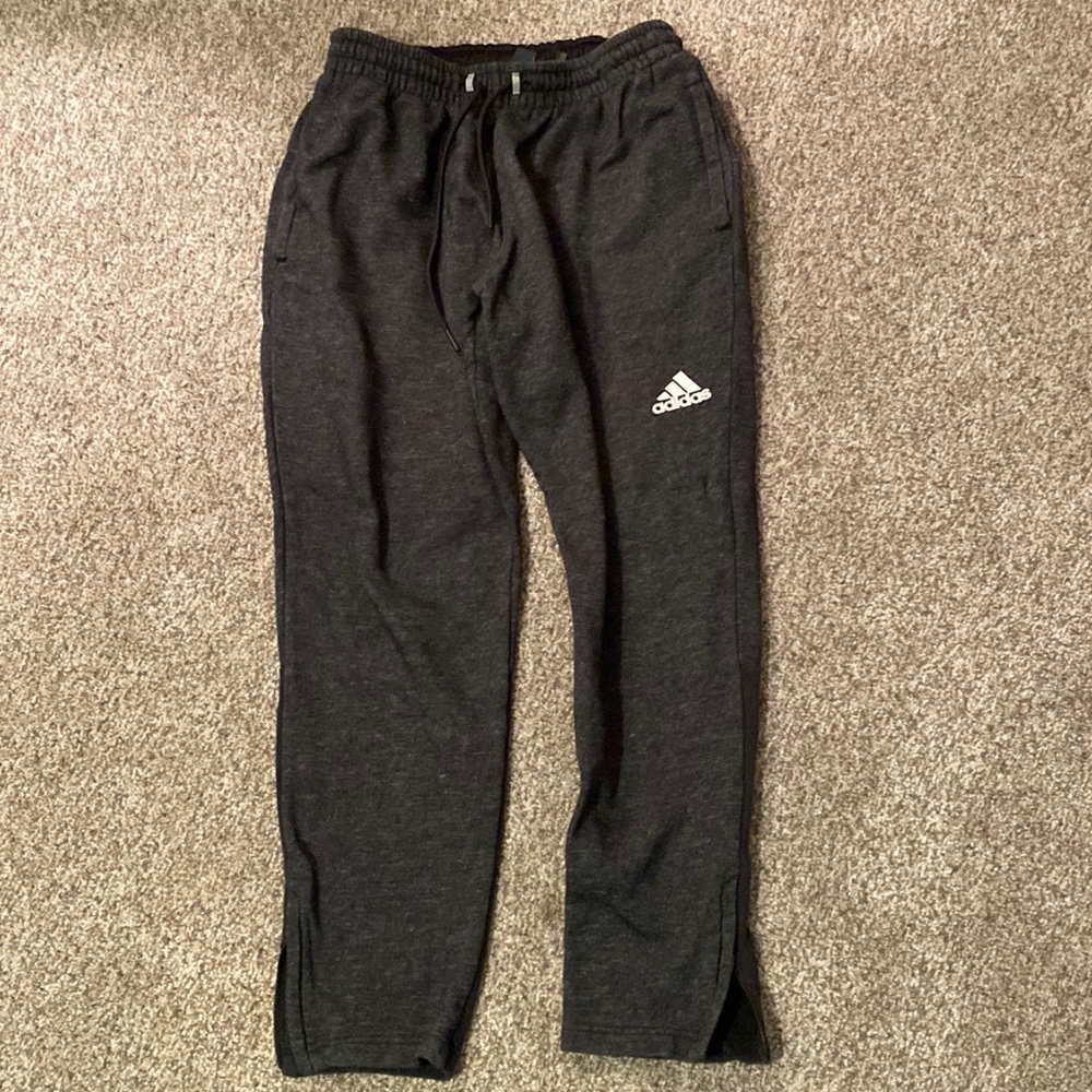 Dark gray Adidas sweatpants.